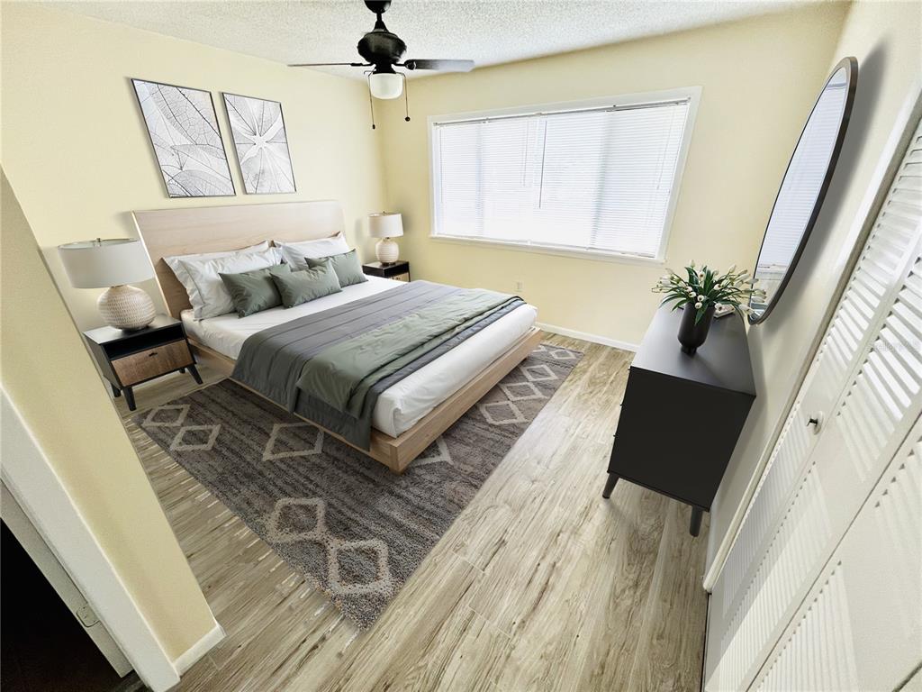 6057 Windhover Drive, Unit E08 Orlando, FL 32819 - Photo 7 of 21 a bedroom with a bed and a window