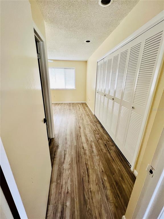 6057 Windhover Drive, Unit E08 Orlando, FL 32819 - Photo 7 of 19 a view of a hallway and wooden floor