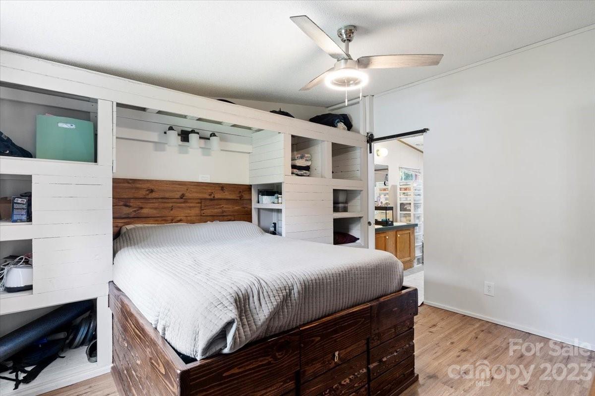 1785 Churchill Road Connelly Springs, NC 28612 - Photo 12 of 27 a bedroom with a bed and a ceiling fan
