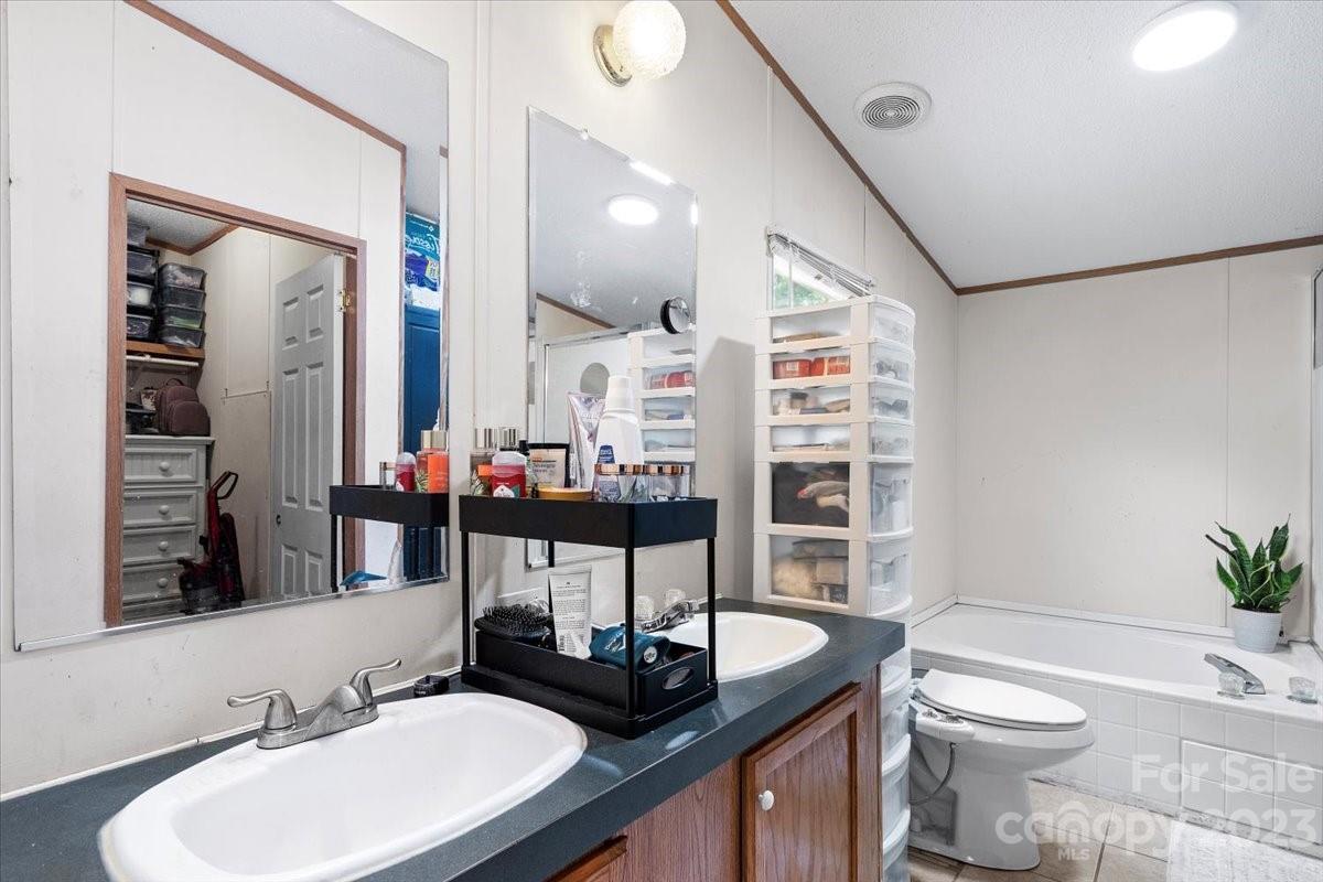1785 Churchill Road Connelly Springs, NC 28612 - Photo 14 of 27 a bathroom with a sink a toilet and a mirror