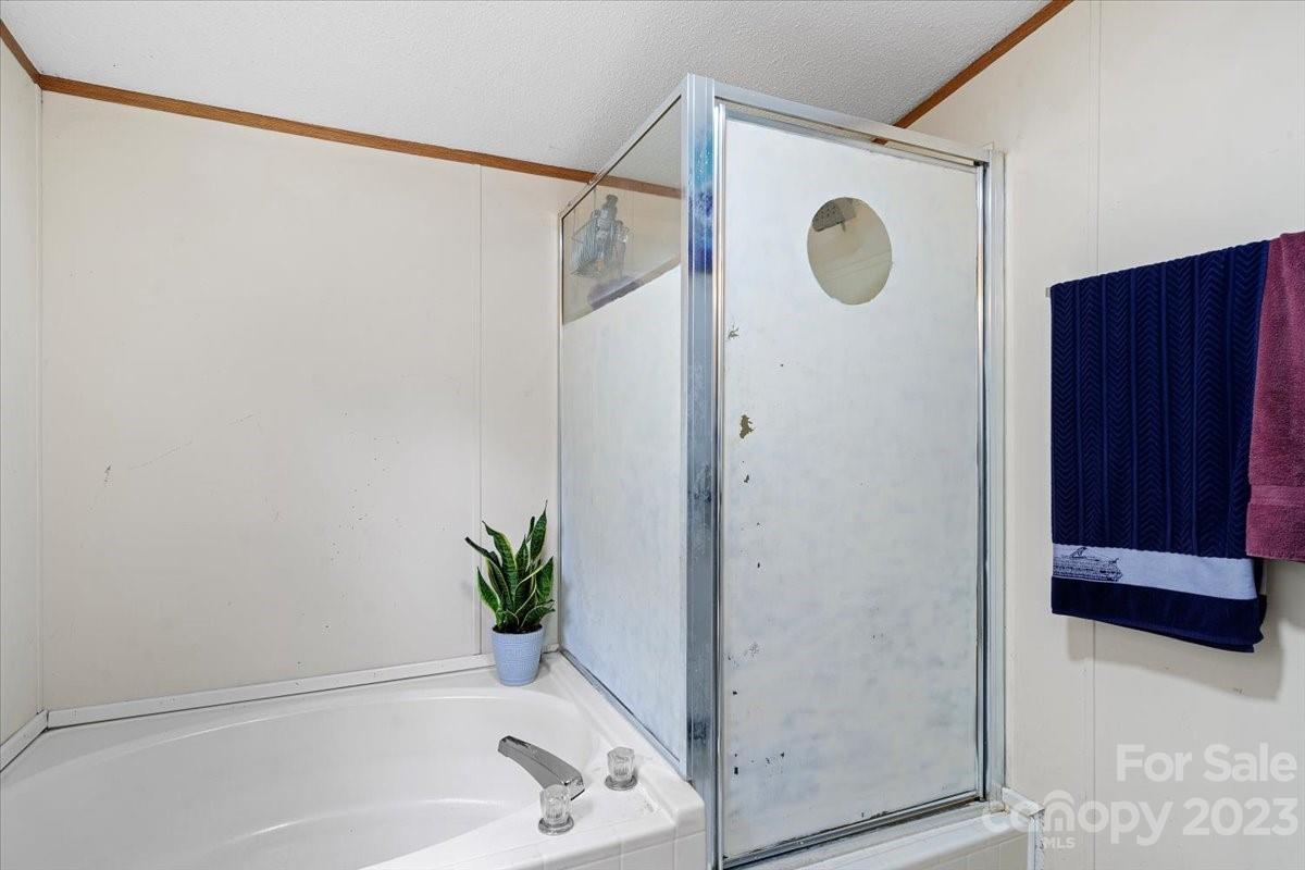 1785 Churchill Road Connelly Springs, NC 28612 - Photo 15 of 27 a bathroom with a shower and a tub