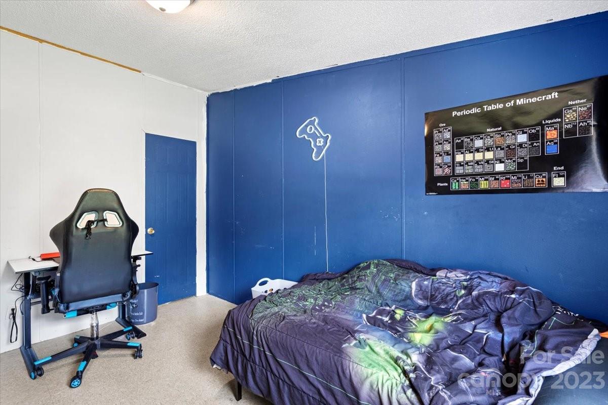 1785 Churchill Road Connelly Springs, NC 28612 - Photo 18 of 27 a bedroom with a bed and a flat screen tv