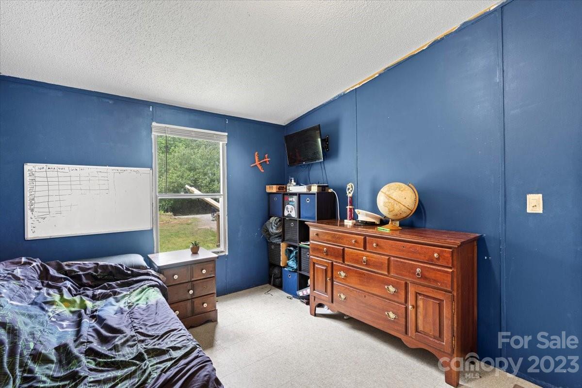 1785 Churchill Road Connelly Springs, NC 28612 - Photo 19 of 27 a bed room with furniture and a window