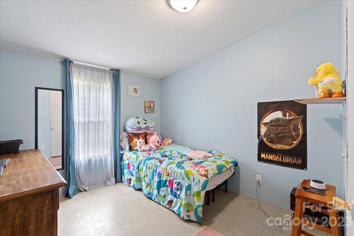 1785 Churchill Road Connelly Springs, NC 28612 - Photo 20 of 27 a bedroom with bed and painting on the wall