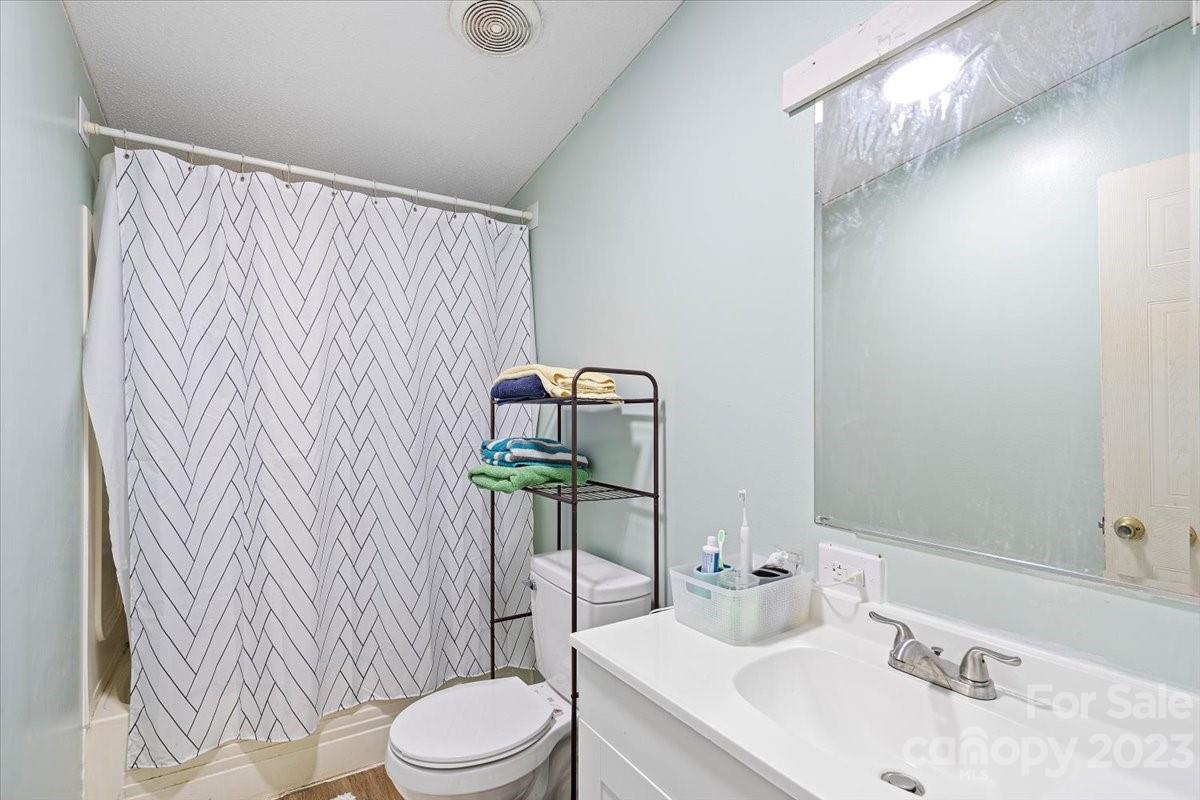 1785 Churchill Road Connelly Springs, NC 28612 - Photo 22 of 27 a bathroom with a sink a toilet and shower curtain