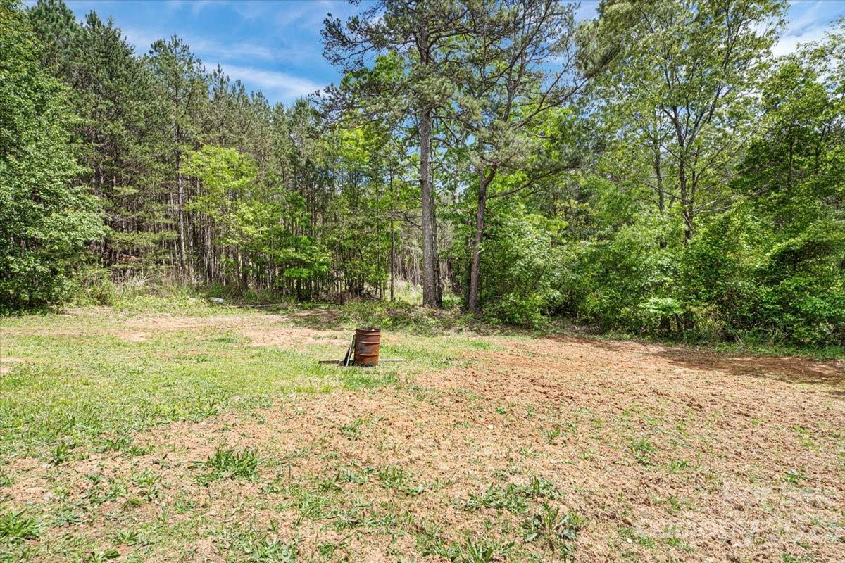 1785 Churchill Road Connelly Springs, NC 28612 - Photo 25 of 27 a view of a field with trees in the background