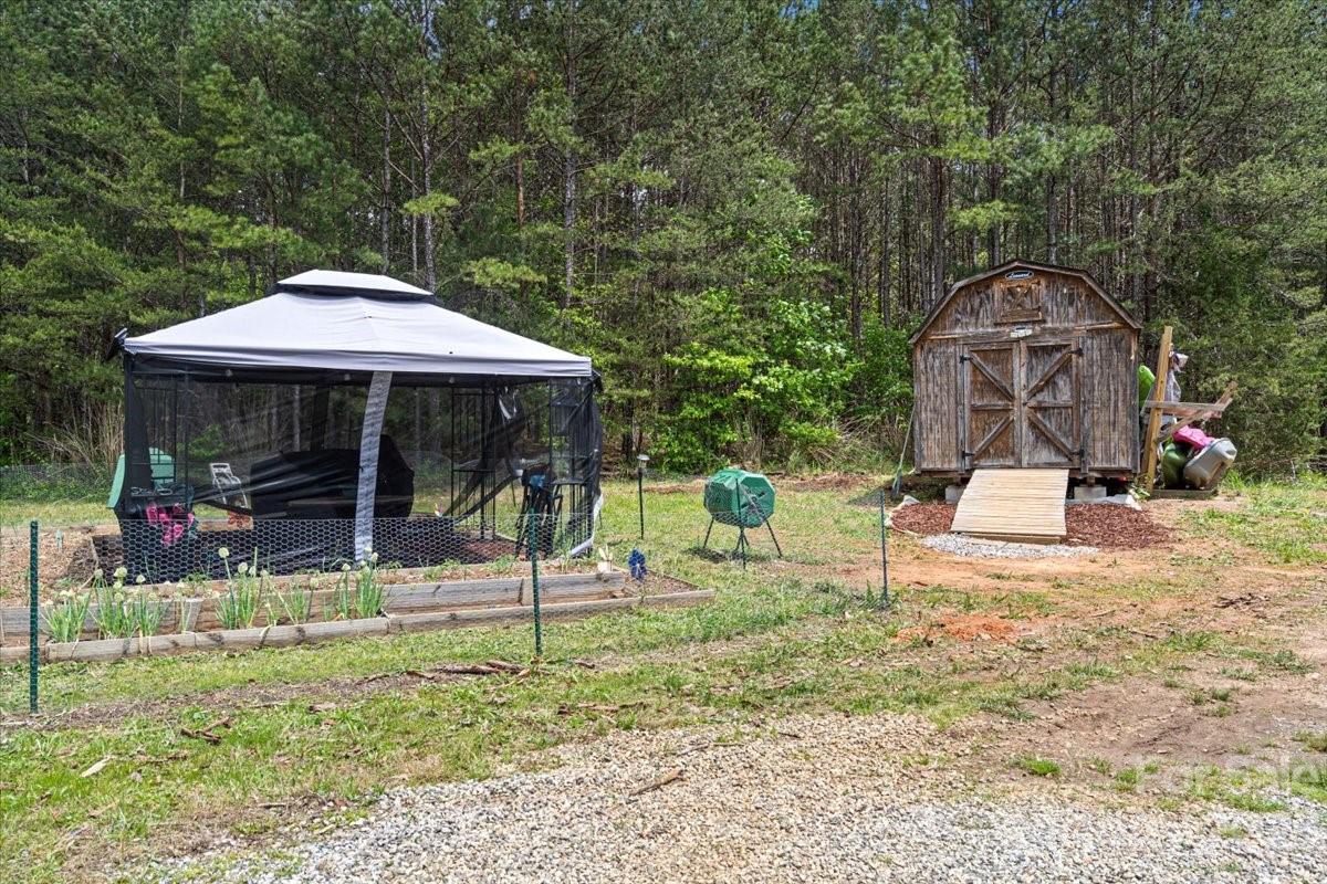 1785 Churchill Road Connelly Springs, NC 28612 - Photo 27 of 27 a view of a park with table and chairs under an umbrella
