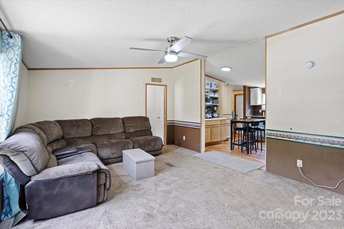 1785 Churchill Road Connelly Springs, NC 28612 - Photo 3 of 27 a living room with furniture and kitchen view