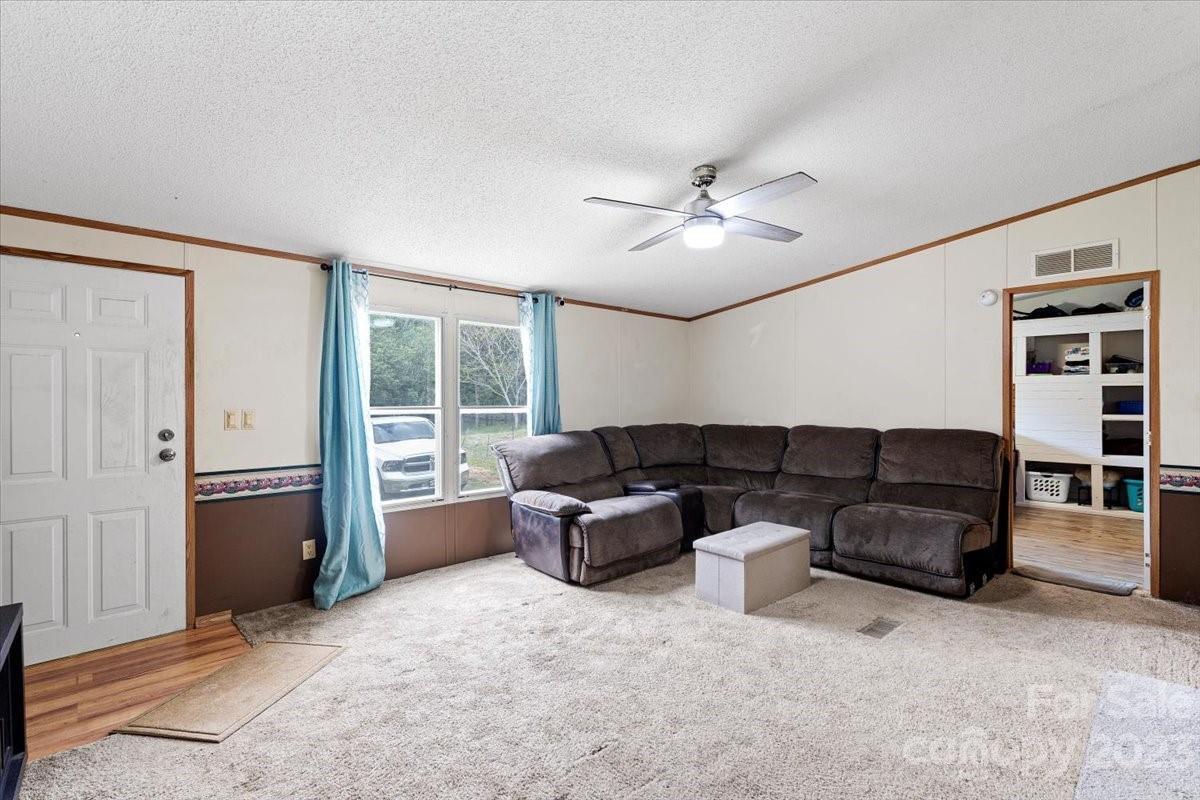 1785 Churchill Road Connelly Springs, NC 28612 - Photo 4 of 27 a living room with furniture and ceiling fan