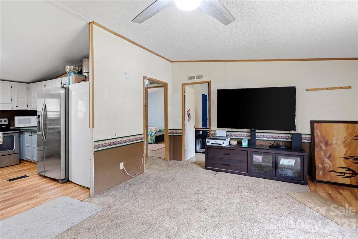 1785 Churchill Road Connelly Springs, NC 28612 - Photo 5 of 27 a living room with furniture and a flat screen tv