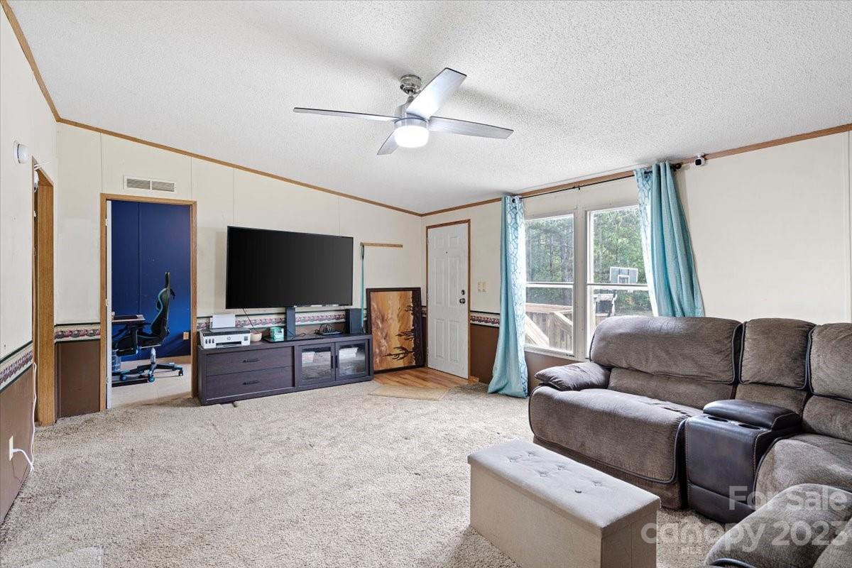 1785 Churchill Road Connelly Springs, NC 28612 - Photo 6 of 27 a living room with furniture and a flat screen tv
