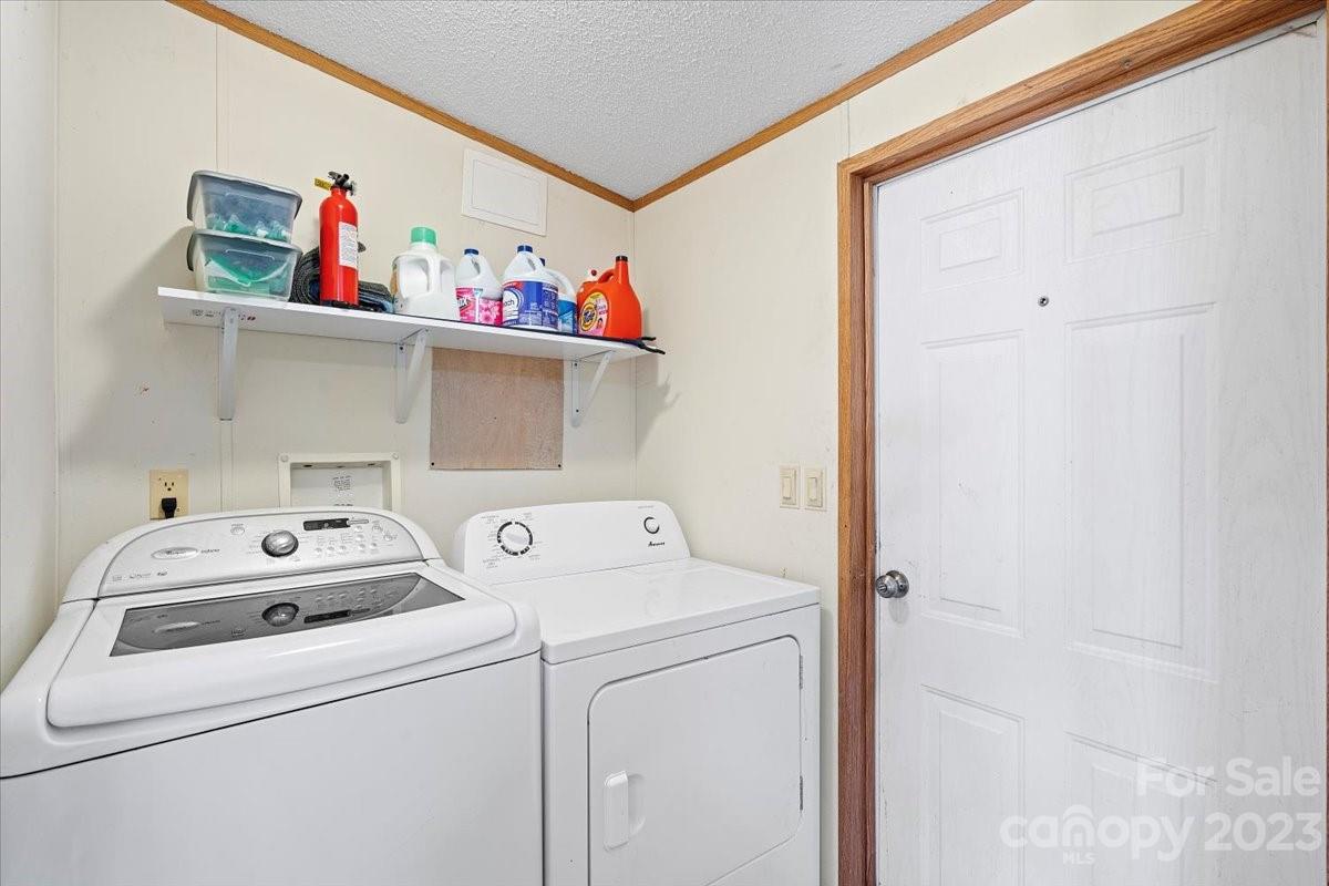 1785 Churchill Road Connelly Springs, NC 28612 - Photo 10 of 27 a utility room with dryer and washer