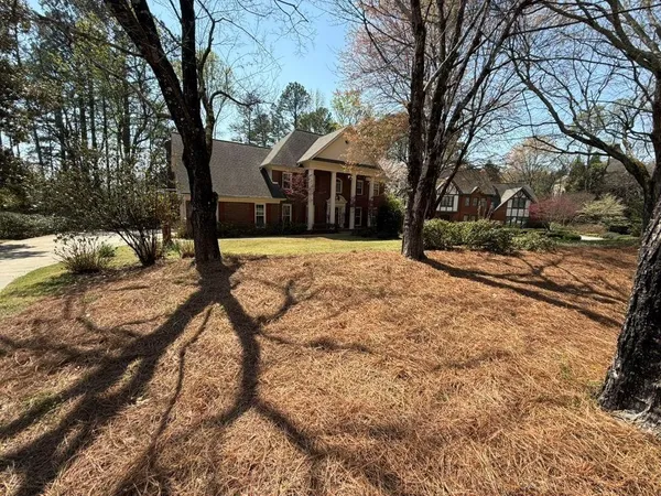 a house that has tree in front of it