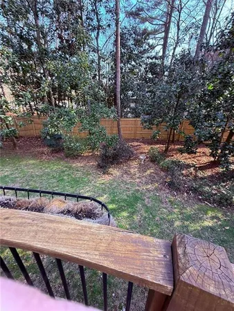 a view of a backyard with wooden fence