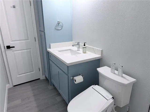 a bathroom with a toilet sink and mirror