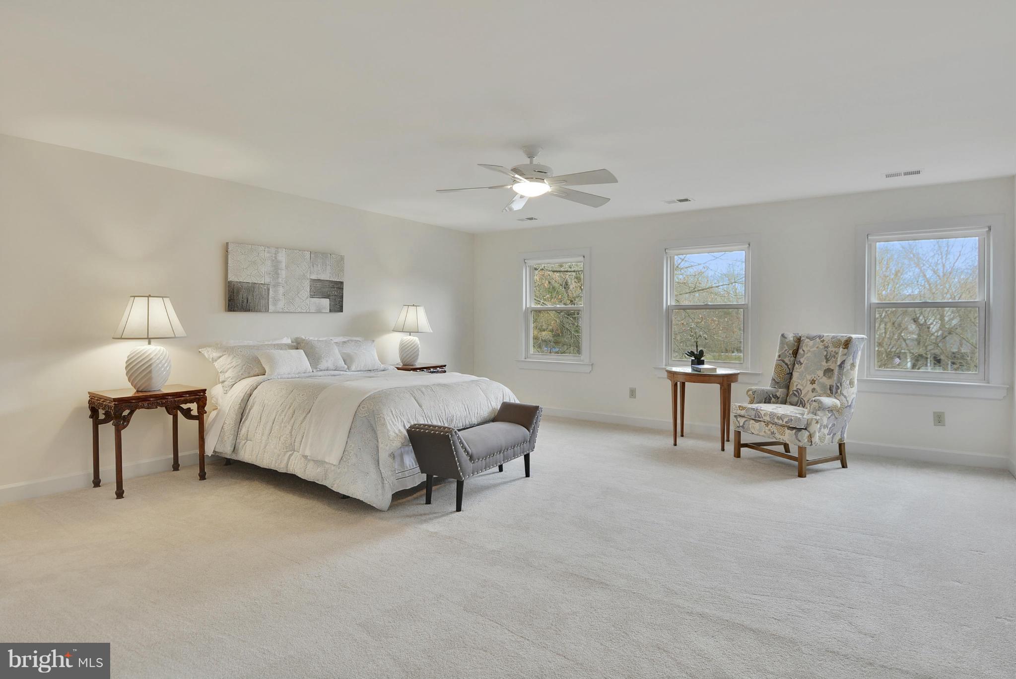 2811 Rifle Ridge Road Oakton, VA 22124 - Photo 14 of 30 a spacious bedroom with a bed and a lamp on table
