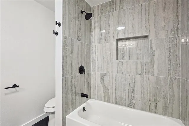 a bathroom with a tub and a shower