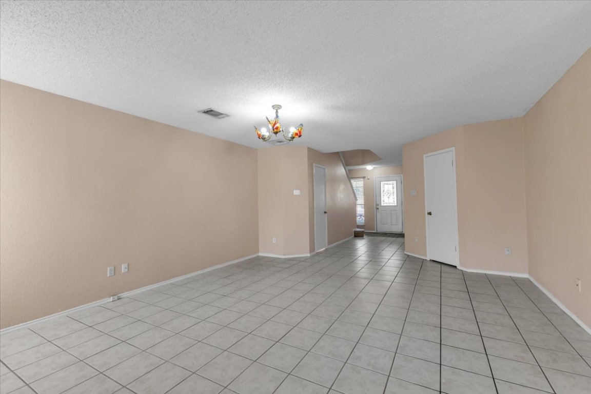 12717 Modena Trail Austin, TX 78729 - Photo 11 of 30 a view of a room with a chandelier fan and window
