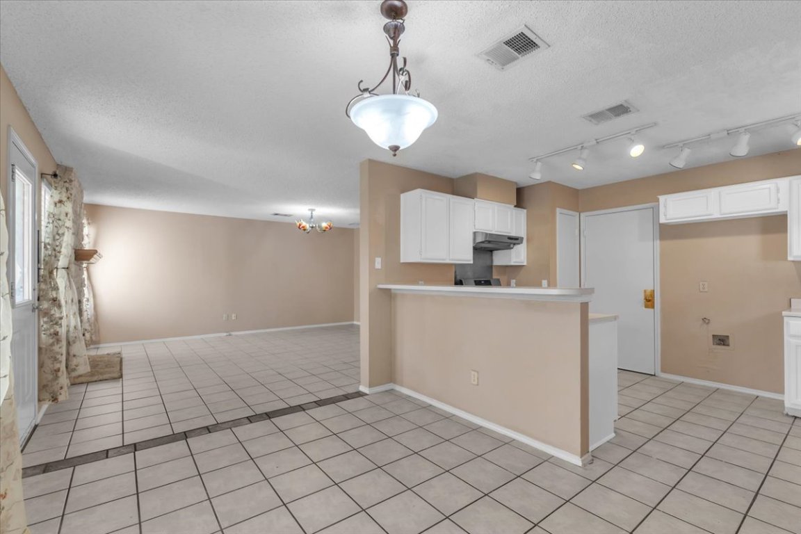12717 Modena Trail Austin, TX 78729 - Photo 30 of 30 a view of a kitchen with a sink and a refrigerator