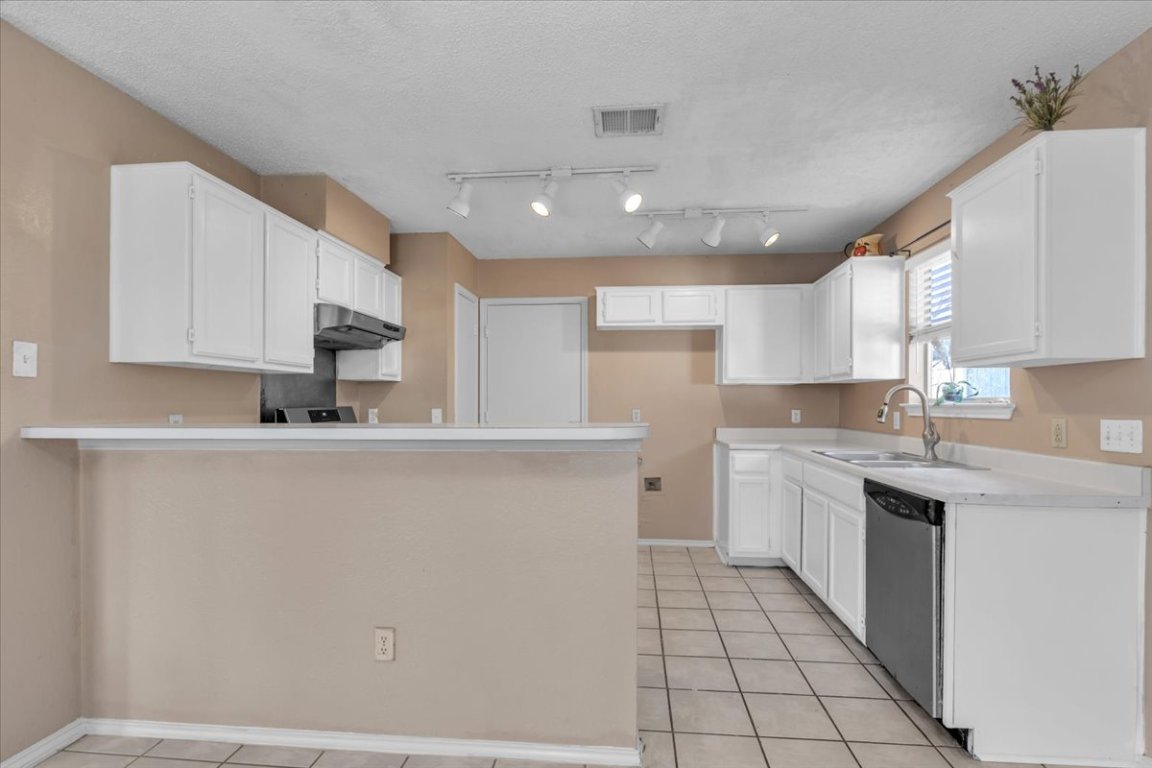 12717 Modena Trail Austin, TX 78729 - Photo 13 of 30 a kitchen with stainless steel appliances a refrigerator sink and cabinets