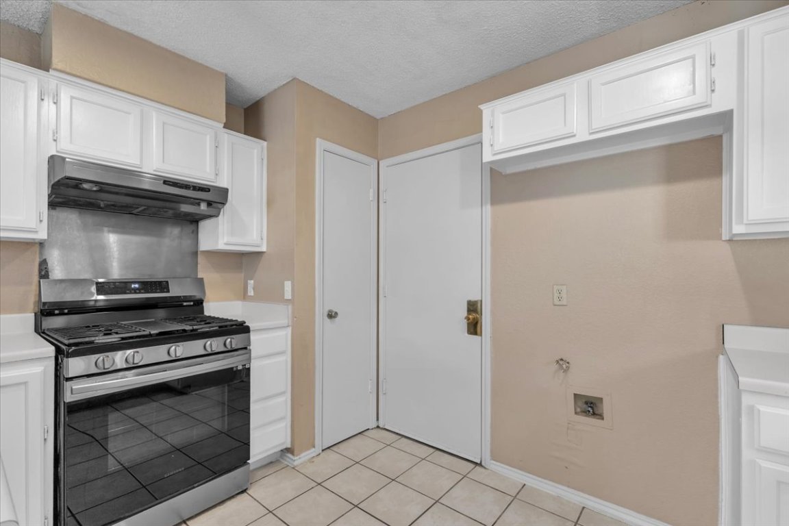 12717 Modena Trail Austin, TX 78729 - Photo 14 of 30 a kitchen with stainless steel appliances a stove and a refrigerator