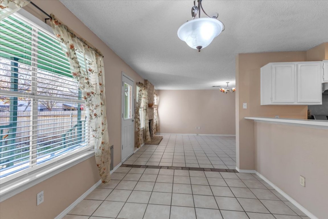 12717 Modena Trail Austin, TX 78729 - Photo 17 of 30 a view of an empty room and window and chandelier fan