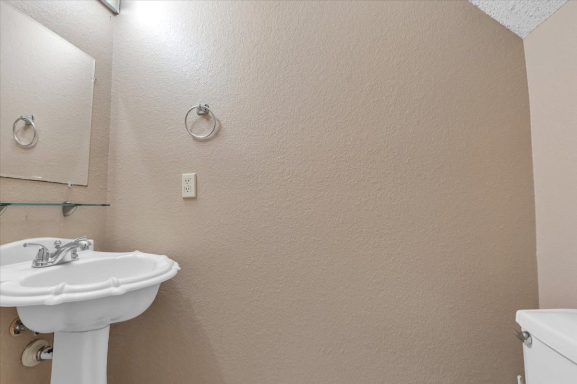 12717 Modena Trail Austin, TX 78729 - Photo 18 of 30 a bathroom with a sink and mirror