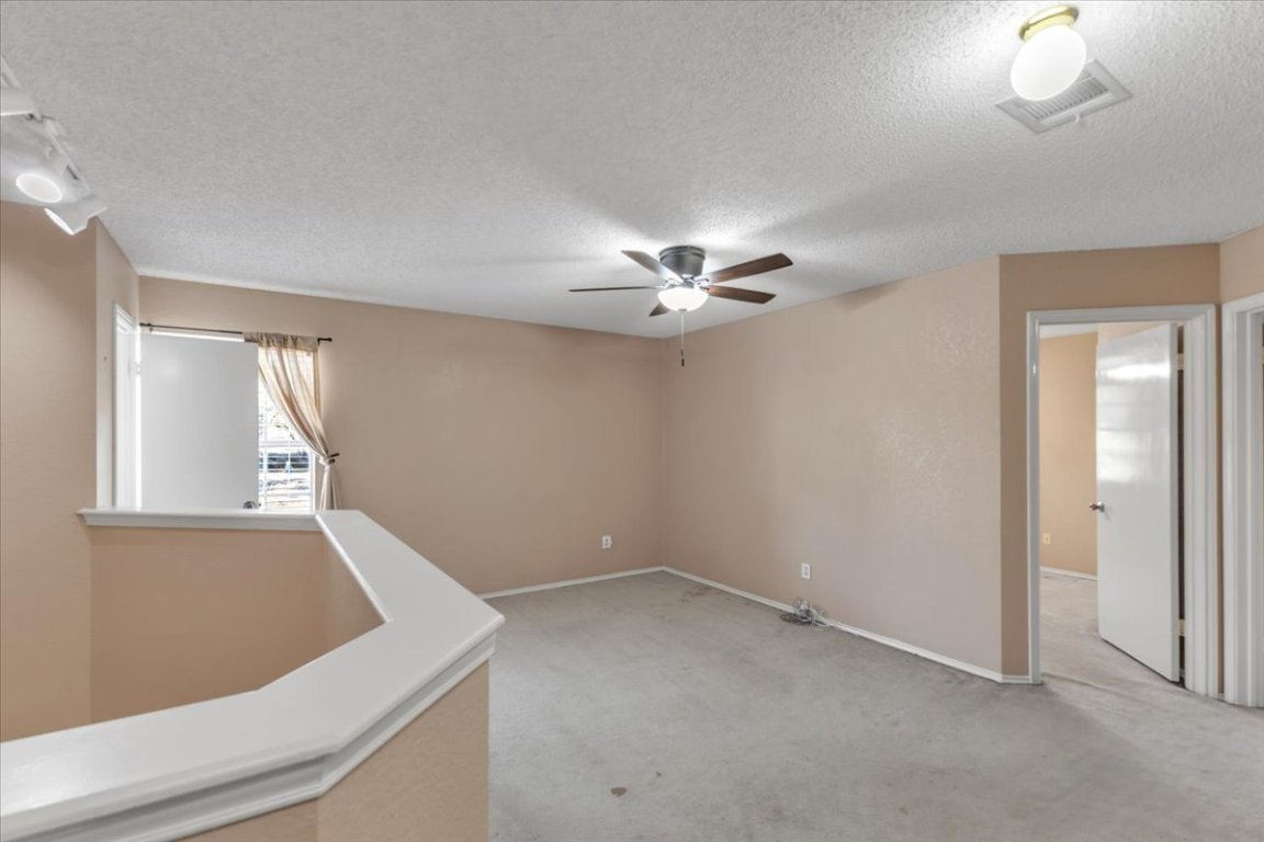 12717 Modena Trail Austin, TX 78729 - Photo 20 of 30 a view of a livingroom with a ceiling fan and window