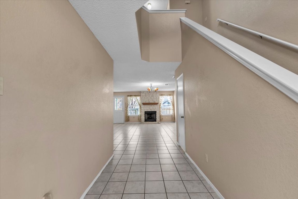 12717 Modena Trail Austin, TX 78729 - Photo 5 of 30 a view of a hallway with wooden floor and staircase