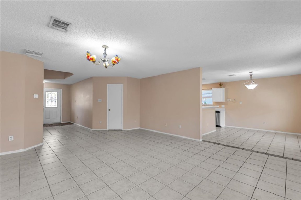 12717 Modena Trail Austin, TX 78729 - Photo 10 of 30 an empty room with windows and fan