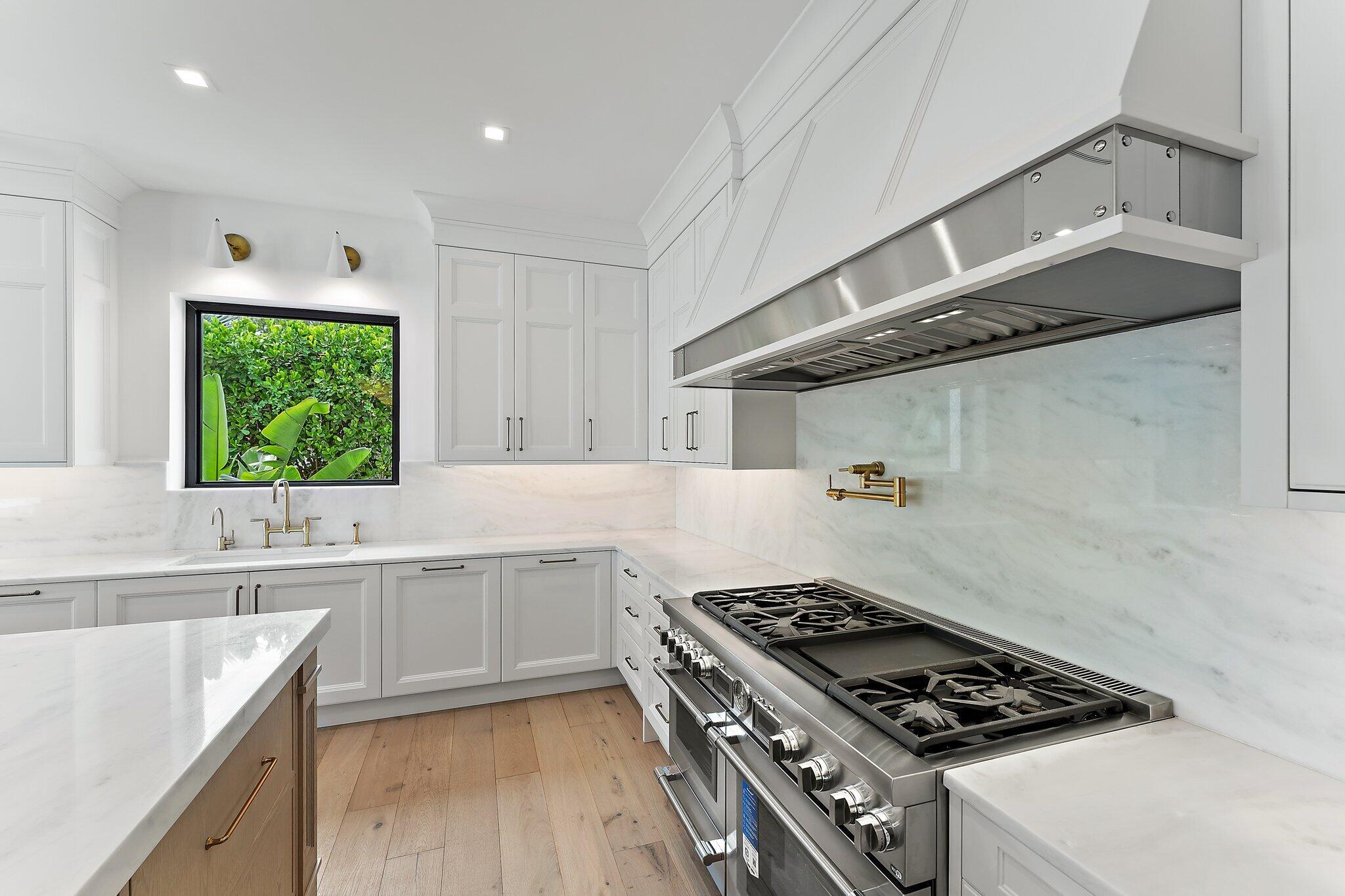 21 Bay Harbor Road Tequesta, FL 33469 - Photo 43 of 89 a kitchen with a stove a sink and a window
