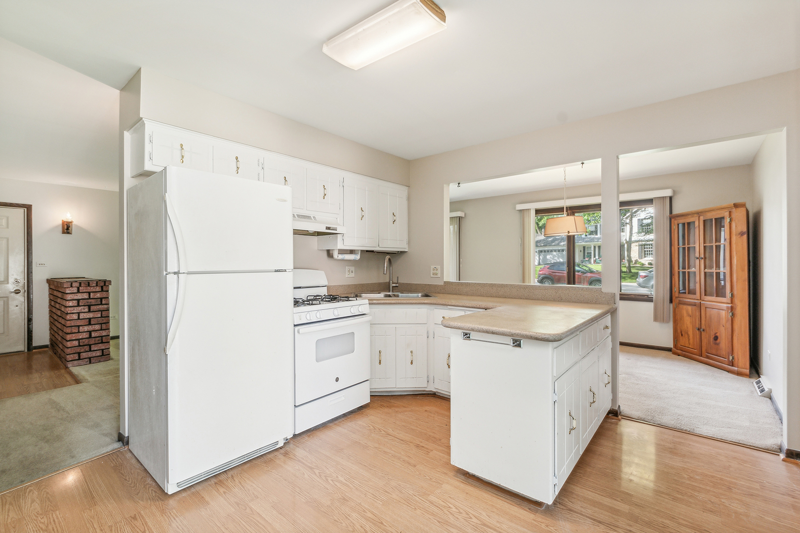 552 Hackberry Road Frankfort, IL 60423 - Photo 7 of 22 a kitchen with white cabinets and white appliances