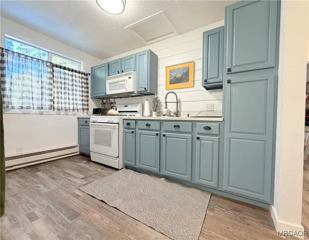 a kitchen with granite countertop a sink stove and refrigerator