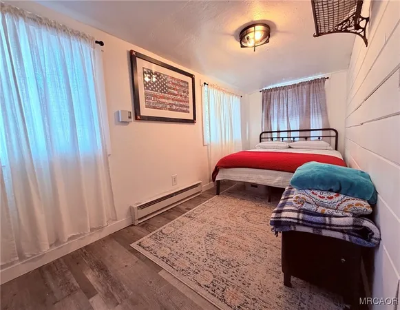 a bedroom with furniture and a wooden floor