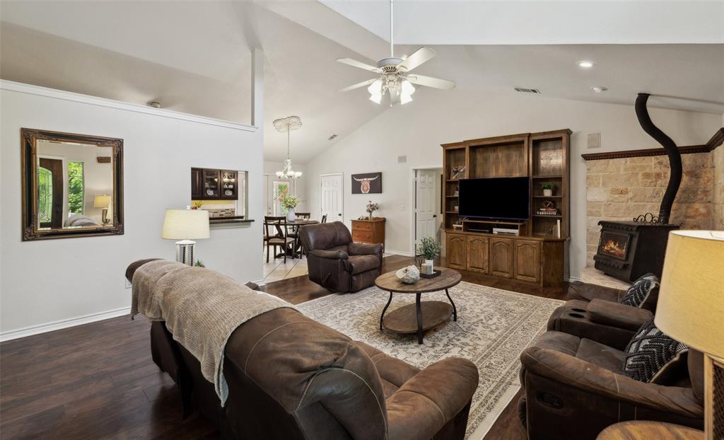 1000 Ballard Road Van Alstyne, TX 75495 - Photo 12 of 40 a living room with furniture a fireplace and a flat screen tv
