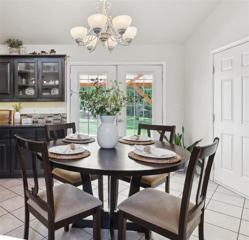1000 Ballard Road Van Alstyne, TX 75495 - Photo 18 of 40 a view of a dining room with furniture and chandelier