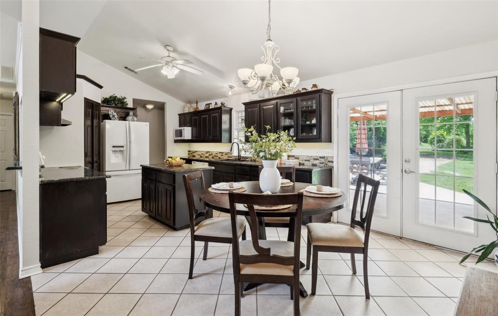 1000 Ballard Road Van Alstyne, TX 75495 - Photo 20 of 40 a view of a dining room with furniture a chandelier and large windows