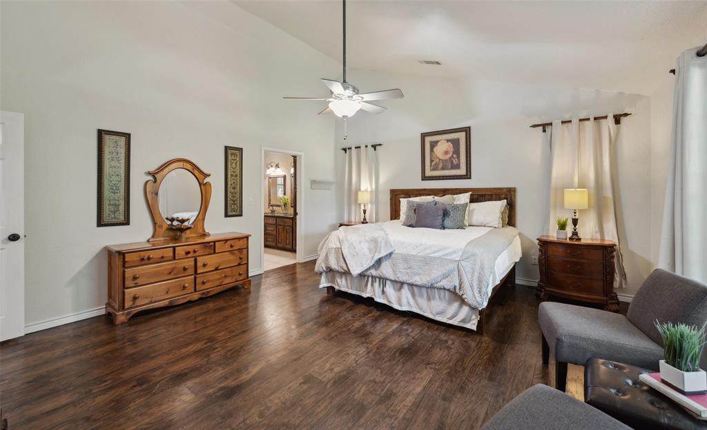 1000 Ballard Road Van Alstyne, TX 75495 - Photo 23 of 40 a bedroom with a bed chandelier and a window