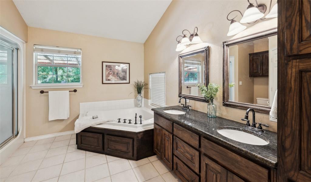 1000 Ballard Road Van Alstyne, TX 75495 - Photo 24 of 40 a bathroom with a tub double vanity sink and a mirror