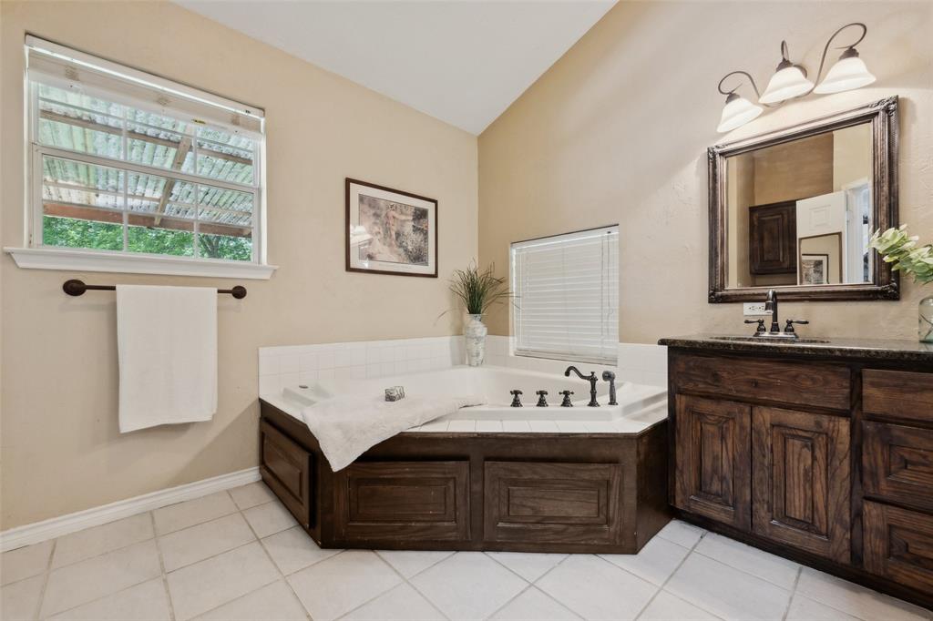 1000 Ballard Road Van Alstyne, TX 75495 - Photo 26 of 40 a bathroom with a sink and a mirror