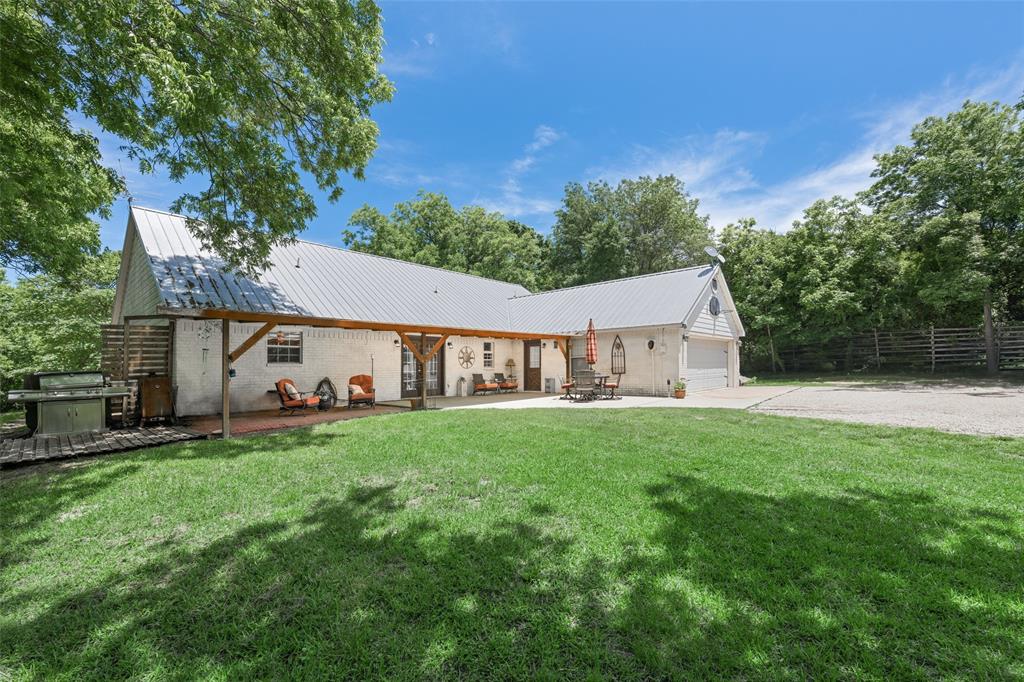 1000 Ballard Road Van Alstyne, TX 75495 - Photo 29 of 40 a view of a big house with a big yard and large trees