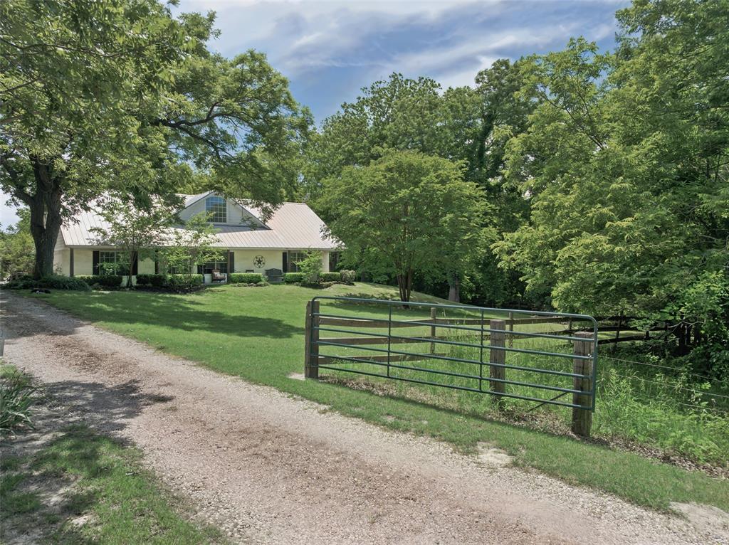 1000 Ballard Road Van Alstyne, TX 75495 - Photo 38 of 40 a front view of a house with garden