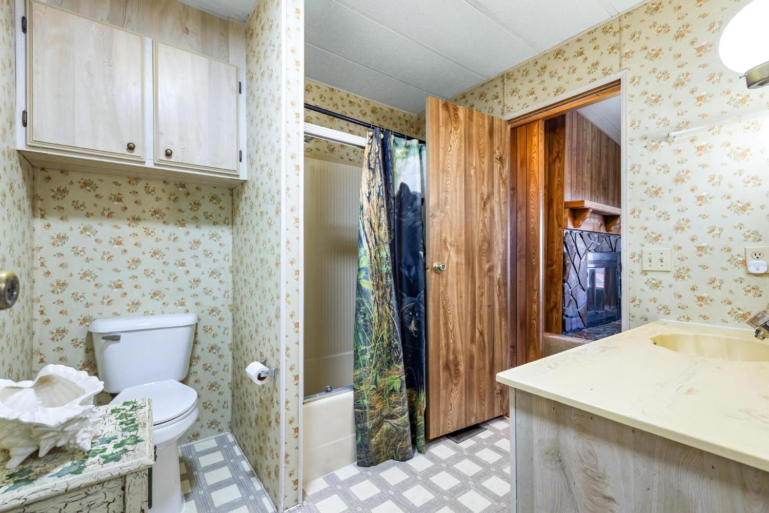 1200 South Carpenter Road, Unit 4 Modesto, CA 95351 - Photo 22 of 31 Bathroom featuring a shower/tub combination, vanity with integrated sink, overhead cabinetry, commode, and patterned flooring