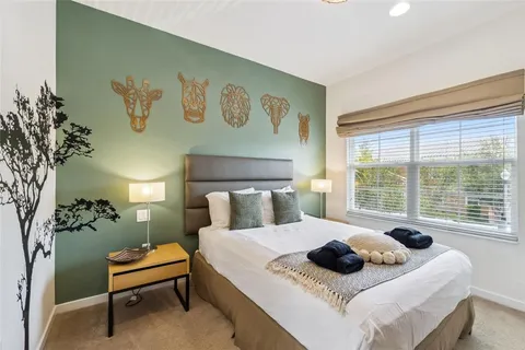 a bedroom with a bed and a large window with garden view