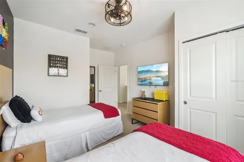 a bedroom with a bed and a chandelier