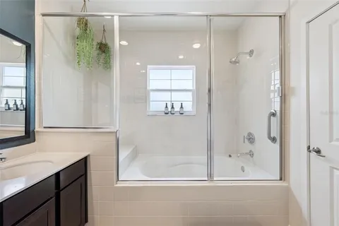 a bathroom with a shower and a sink