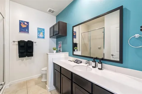 a bathroom with a sink double vanity granite and a mirror