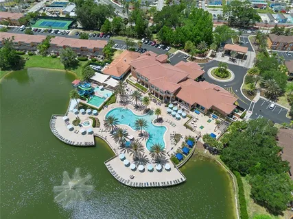 an aerial view of a houses with a lake