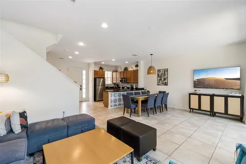 a living room with furniture a rug and a table