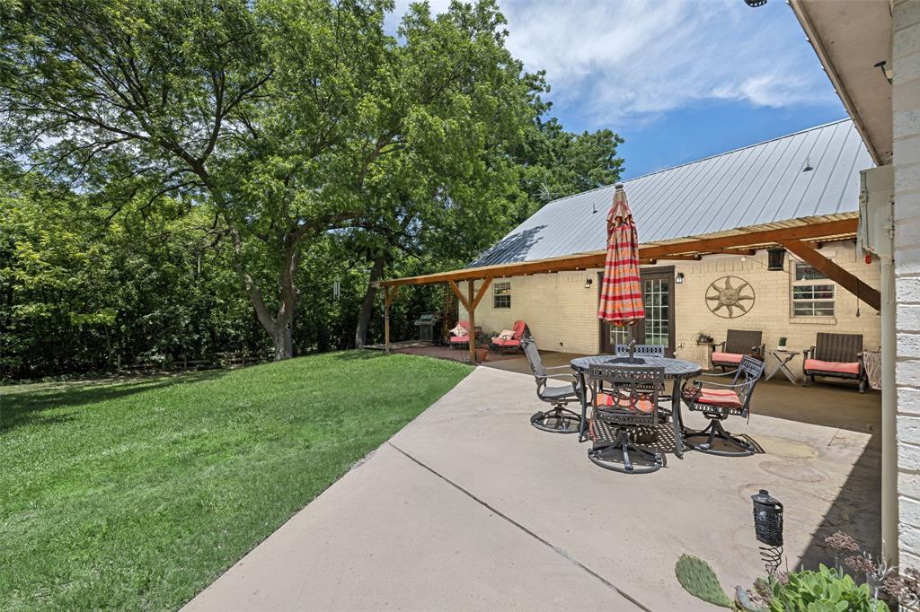 1000 Ballard Road Van Alstyne, TX 75495 - Photo 32 of 40 a view of backyard with table and chairs and potted plants